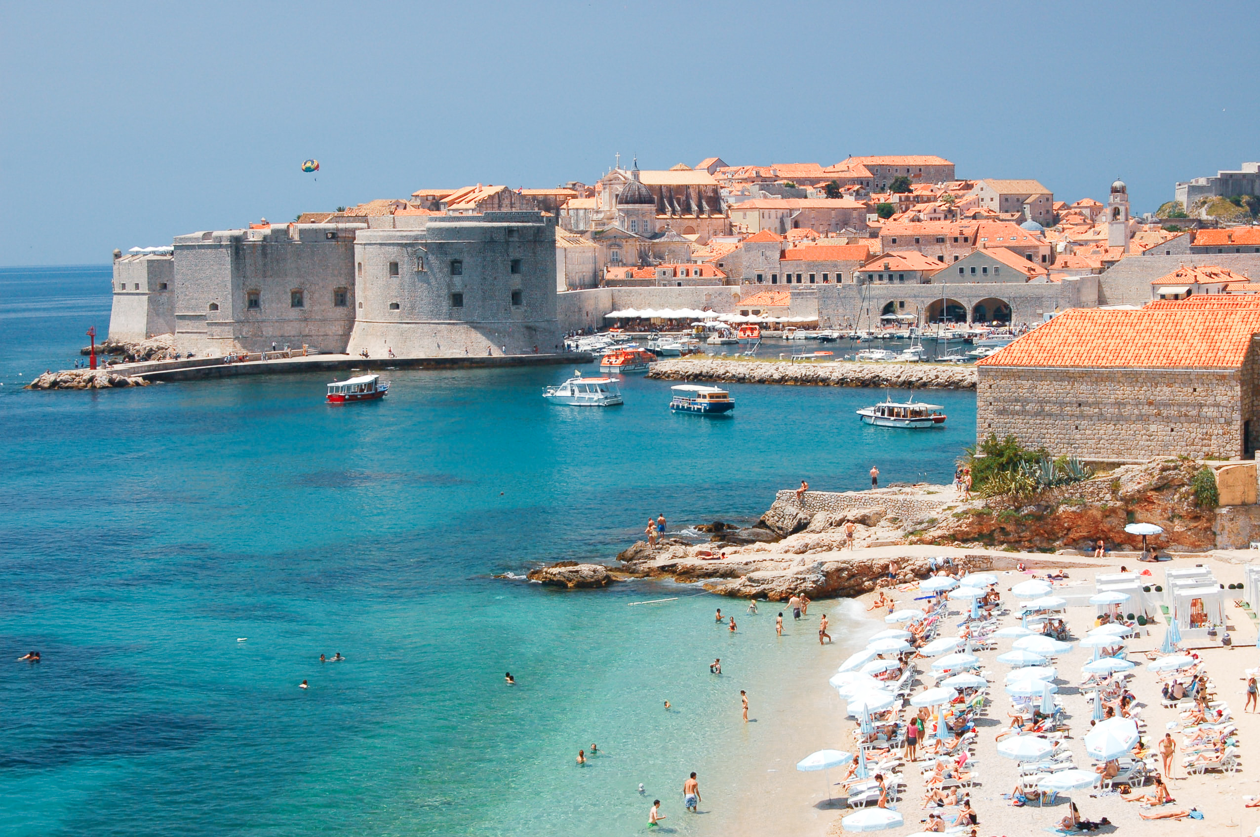 A beach in Croatia surrounded by old buildings