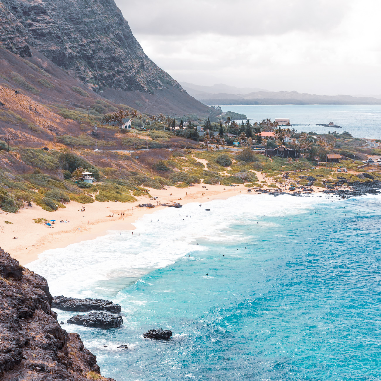 Beach next to mountain cliffs in Hawaii