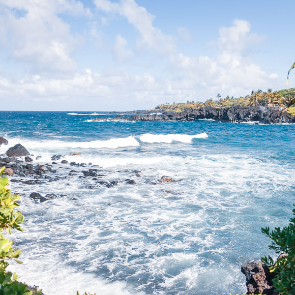 Waves crashing against rocks in Hawaii