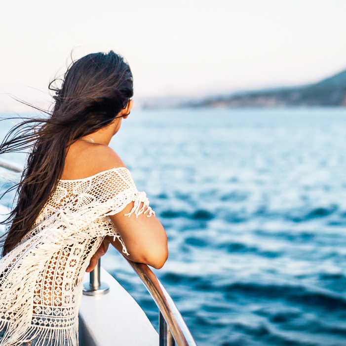 Girl looking out at ocean from boat