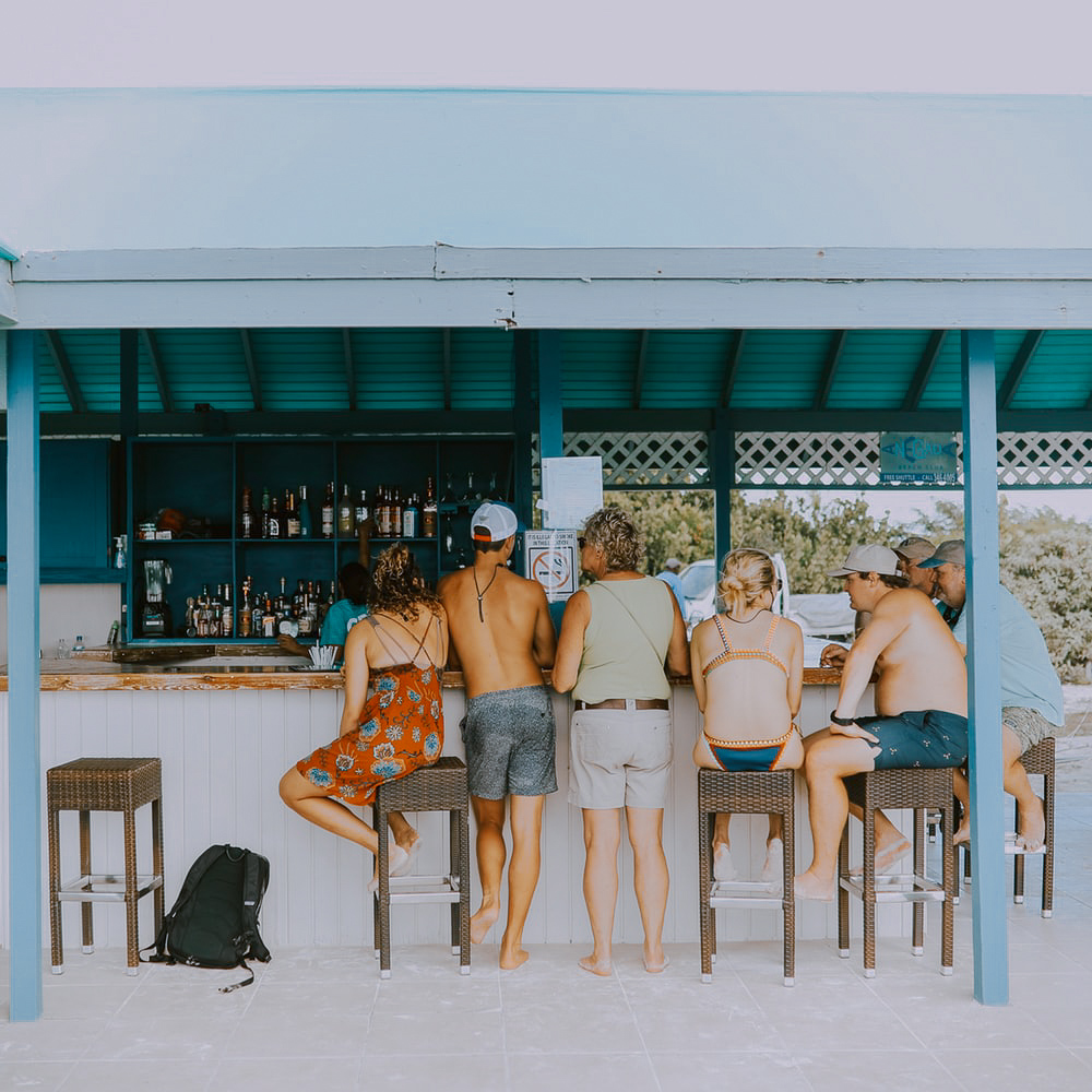 Group of people standing at outdoor bar