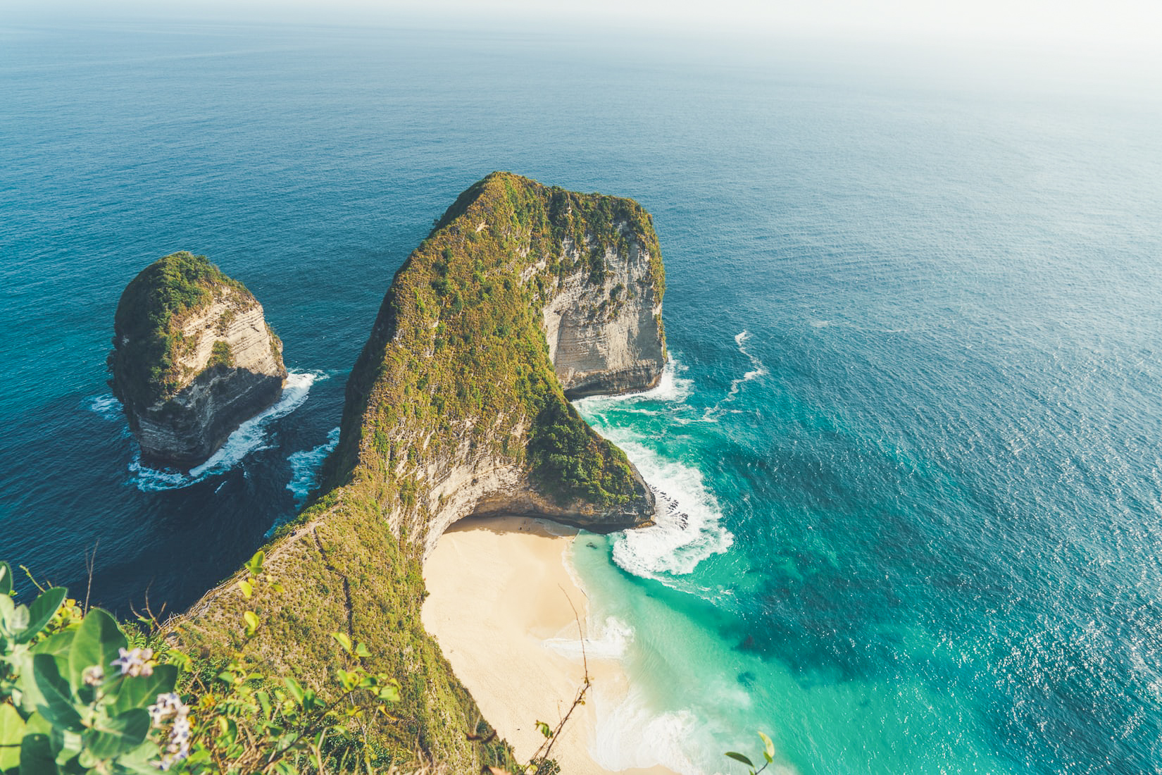 Cliff in Indonesia overlooking a beach and the ocean